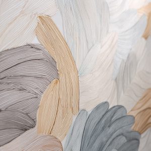 Artistic textured wall designs with abstract leaf strokes in soft beige, grey and muted pastel tones