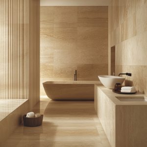 Luxury italian marble designs with warm beige tones in modern bathroom with stone tub and elegant finish