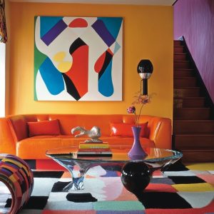 Colorful living room with vintage home decor ideas and orange sofa with bold artwork