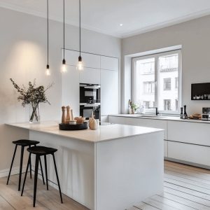 Simple indian kitchen design with white cabinets island and large kitchen window layout