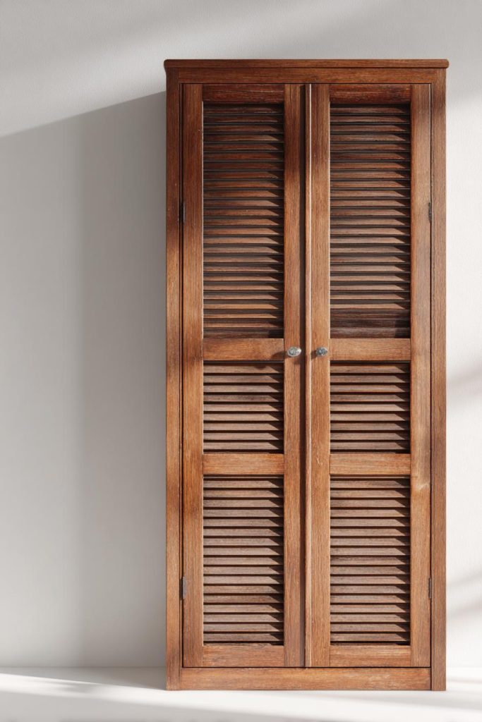 Louvered door wardrobe in solid wood finish with ventilated panels and classic design
