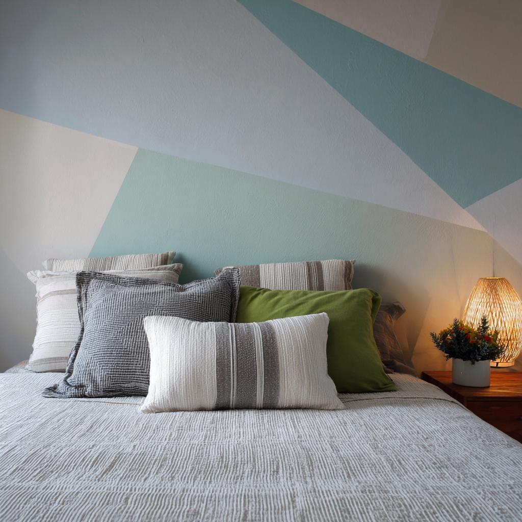 Soft pastel blue and cream easy wall designs with tape creating a large geometric mural