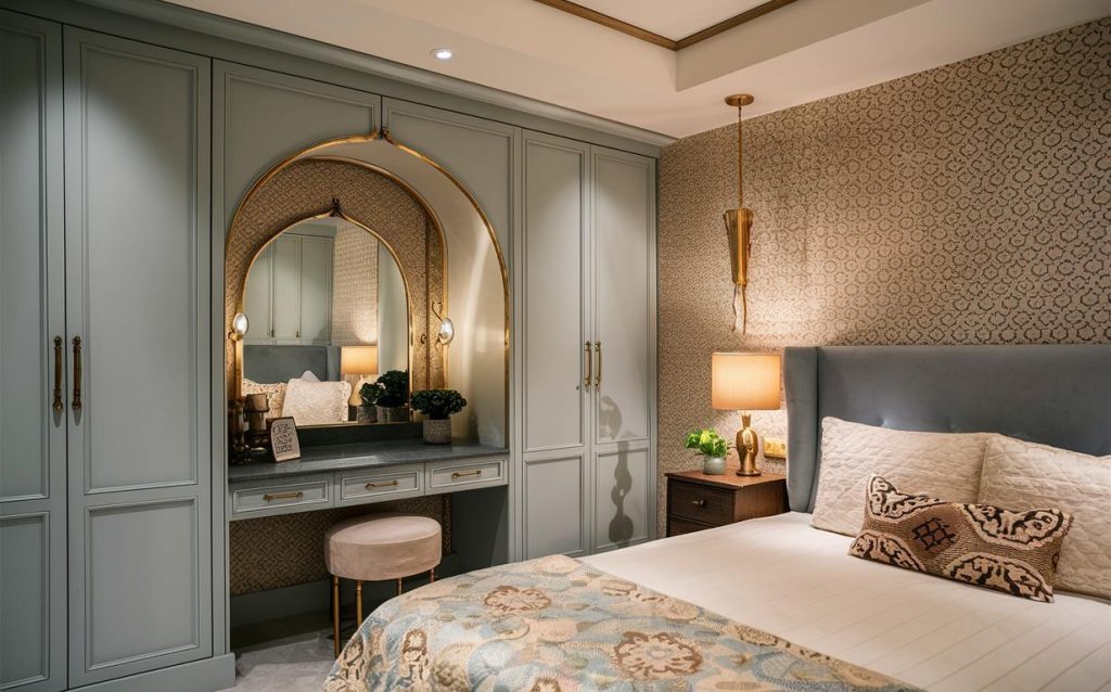 Elegant bedroom cupboard design with dressing table featuring classic mirror and soft pastel cabinetry