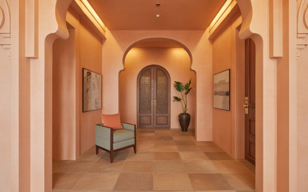 Elegant hall interior colour combination with warm earthy tones and arched design for a premium look