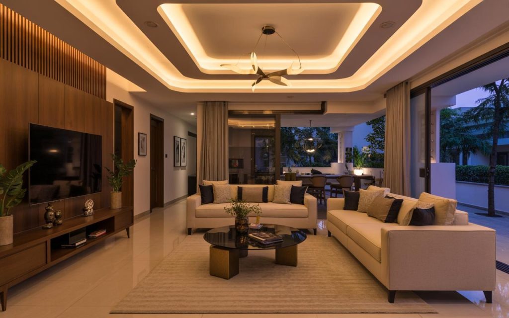 Latest ceiling design for living room with layered lighting and fan creating a warm elegant space