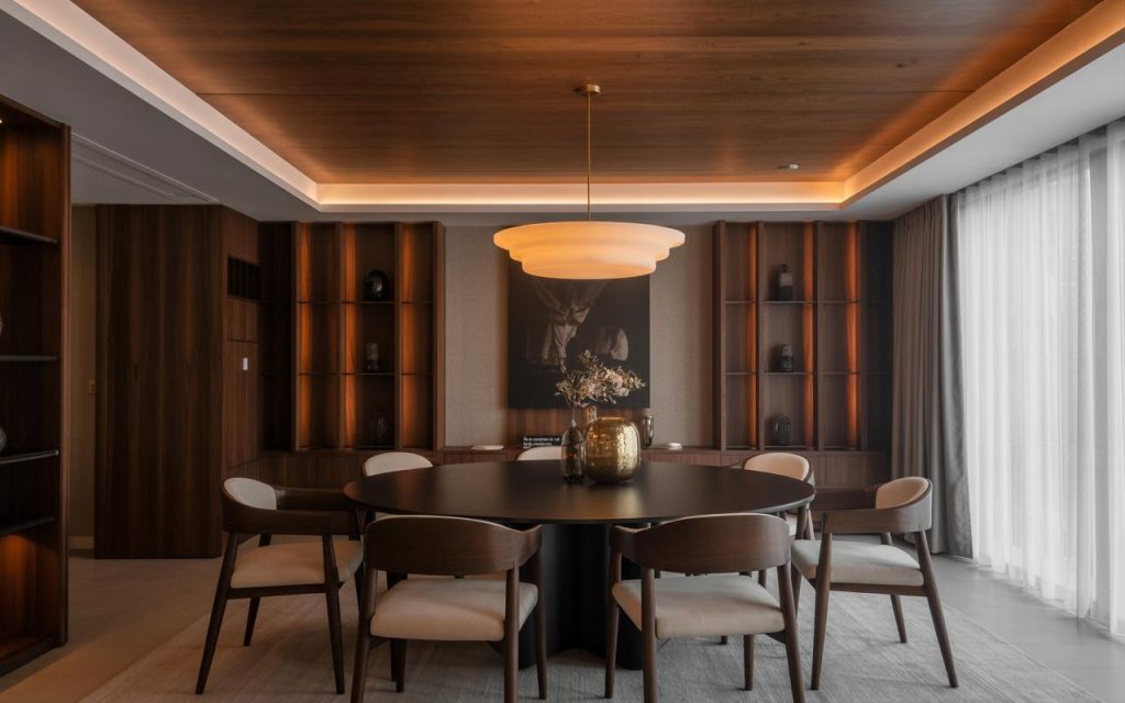 Elegant latest ceiling design for living room with warm lighting and wooden panels creating a cozy dining space