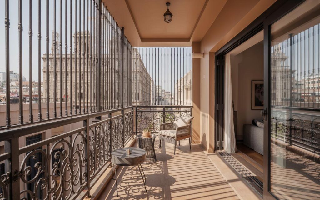 Elegant balcony railing design iron featuring vertical bars and decorative grill with cozy seating area