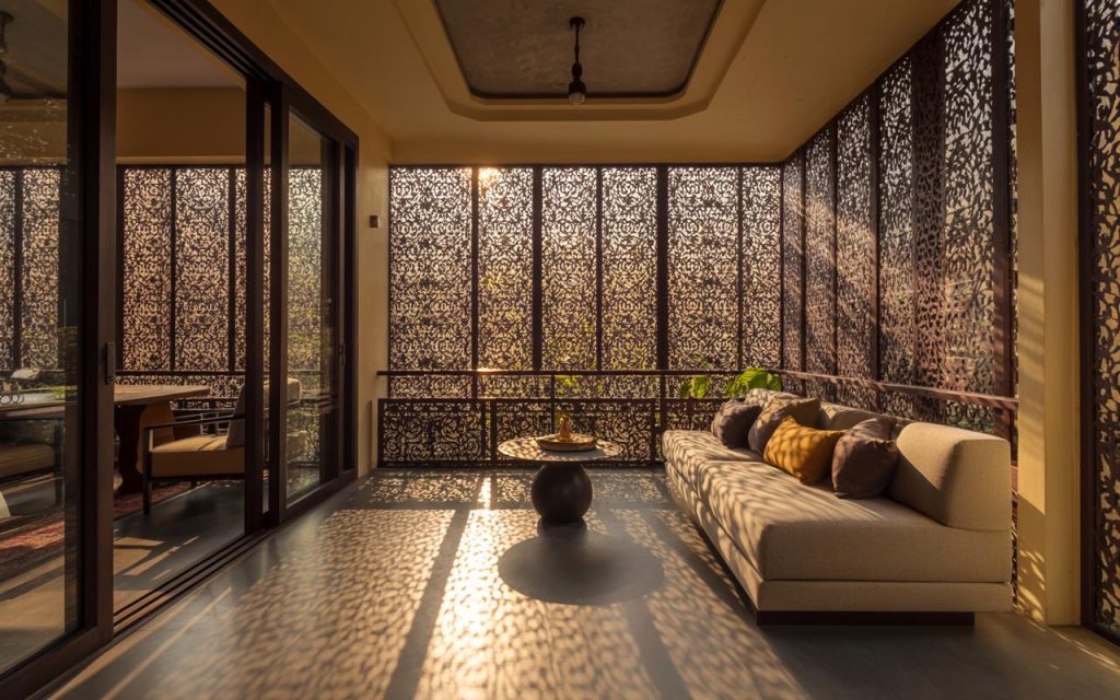 Elegant iron grill design for balcony railing featuring intricate panels with warm ambient lighting