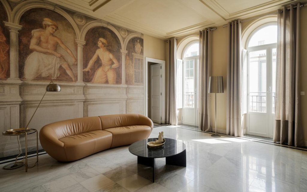 Elegant italian interior design living room with arched windows, fresco walls and luxurious marble flooring
