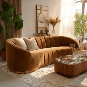 Trendy Livingroom trends with curved velvet sofa, warm tones and modern cozy aesthetic interior design