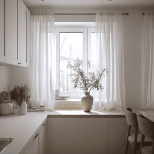 Cozy small kitchen curtain ideas with sheer white drapes creating a soft, airy and minimal window space