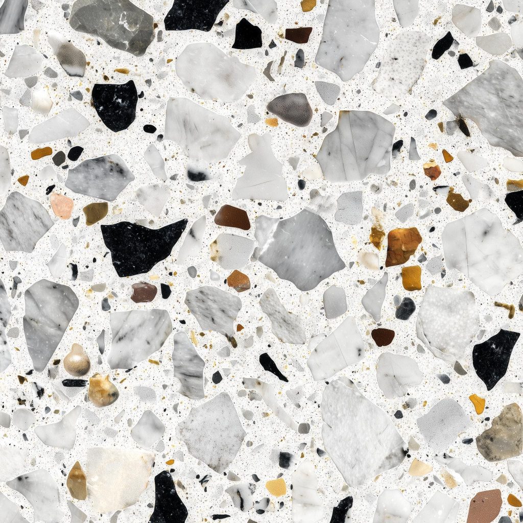 Polished white terrazzo stone with large grey marble chips and smaller colorful speckled chips.