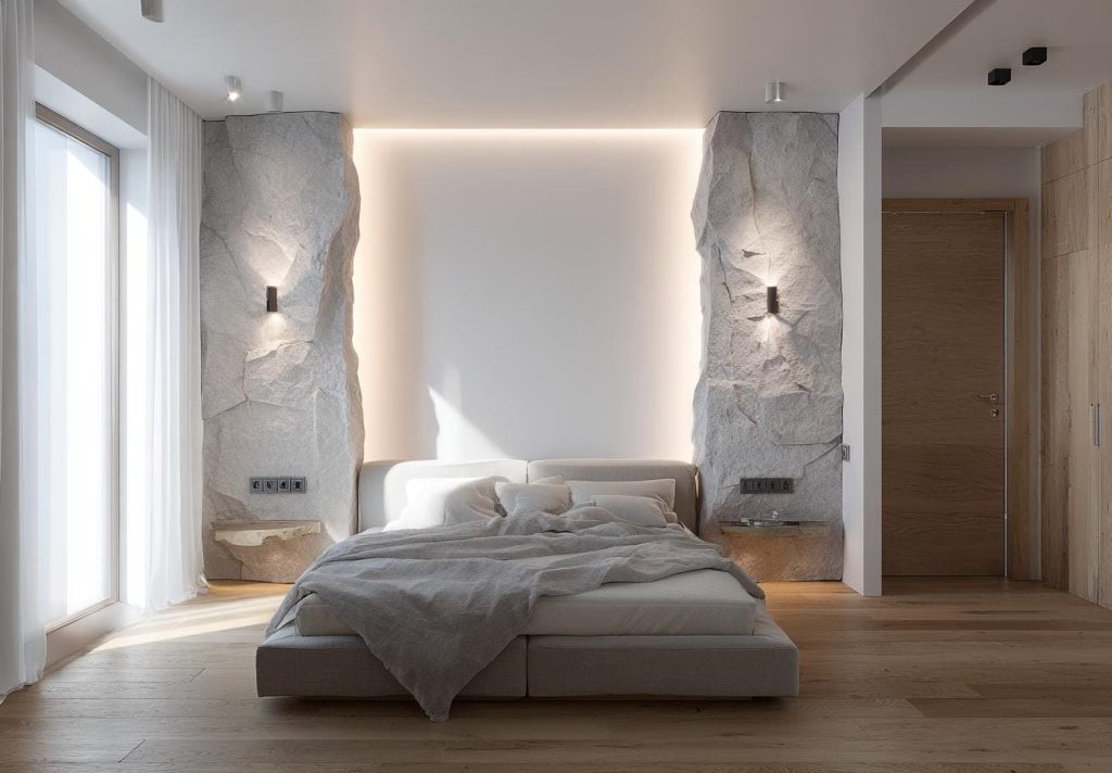 Contemporary bedroom back wall design with stone panels, warm lighting, and minimalist decor
