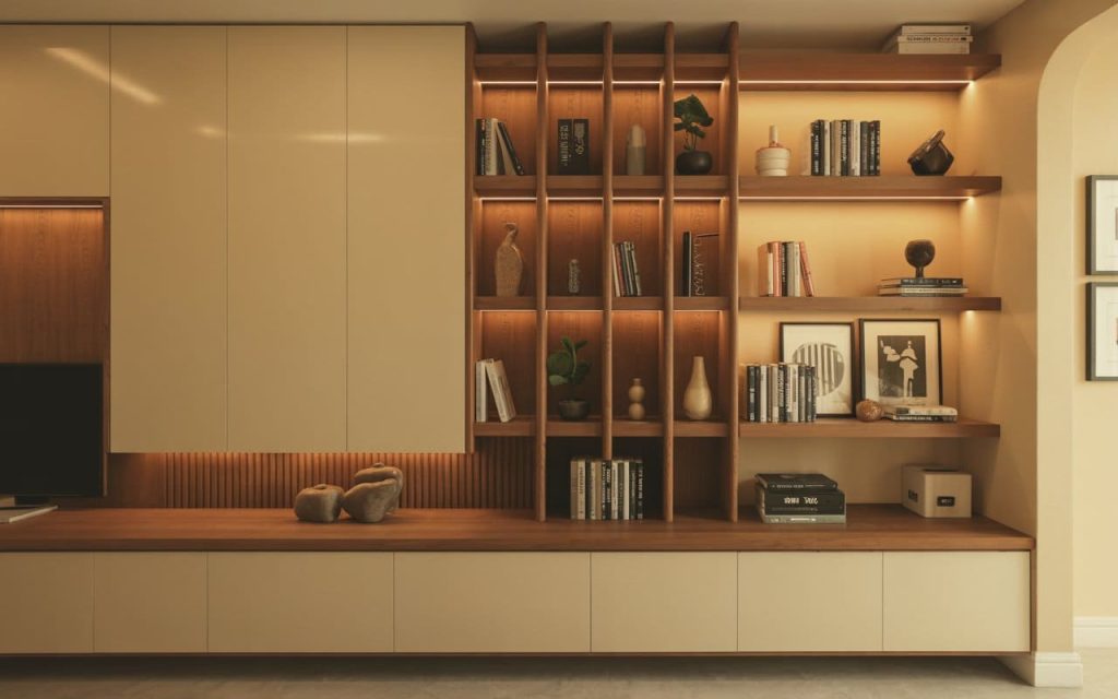 A simple partition design for living room and dining hall with wooden open bookshelves.