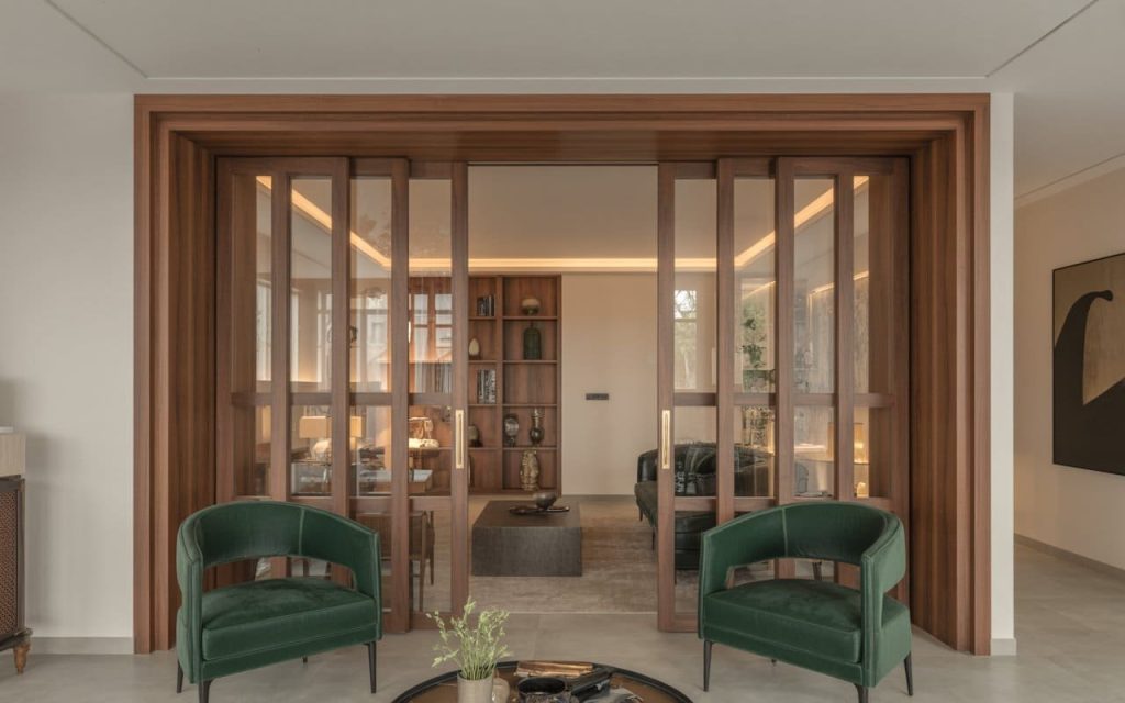 A modern glass and timber room divider treated with a natural wood polish for a soft glow.