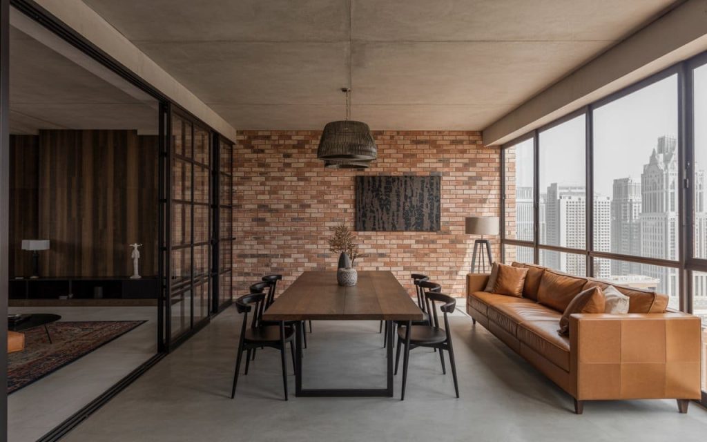  Exposed brick walls and leather seating define this industrial style interior design.