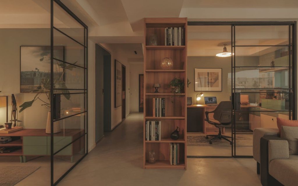 Modern home remodeling trends with glass partitions and open workspace design for stylish interiors