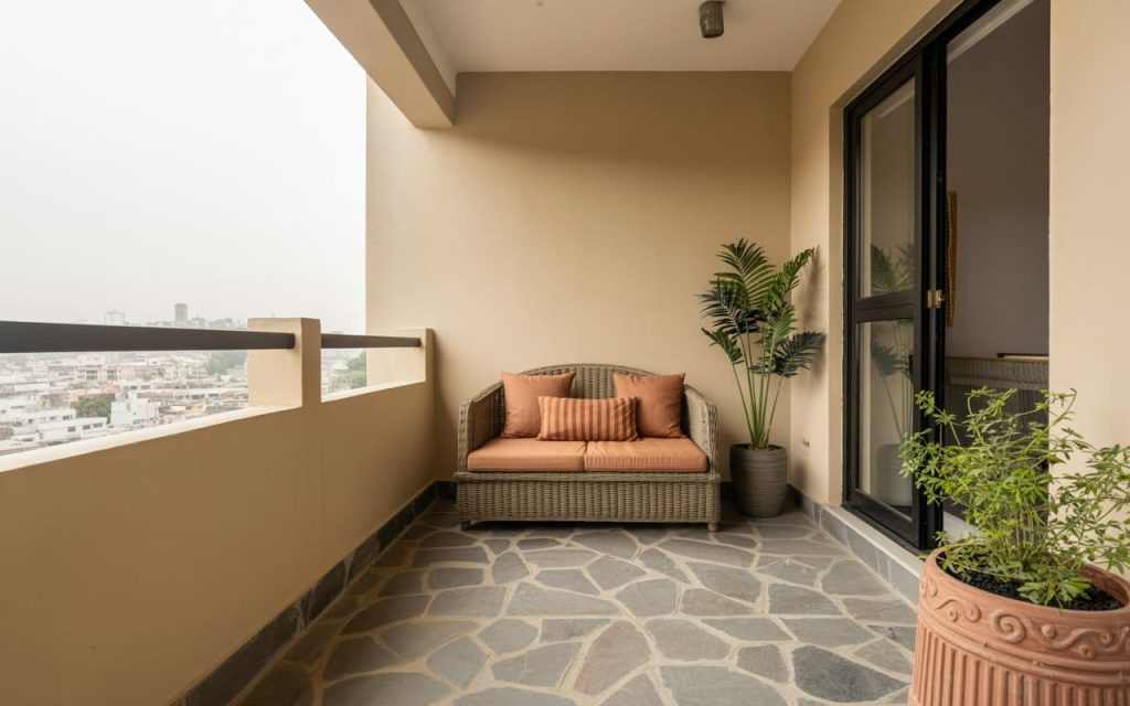 Inspiring balcony colour ideas featuring warm peach walls and rustic stone floor tiling.