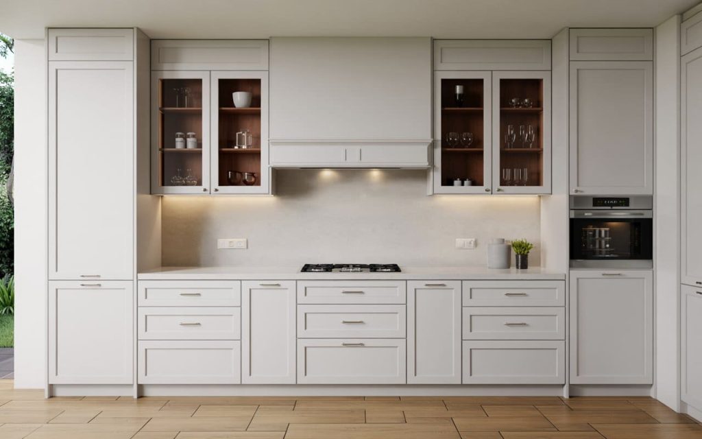 Contemporary gray kitchen cabinets with brass hardware accents and warm under-cabinet lights.