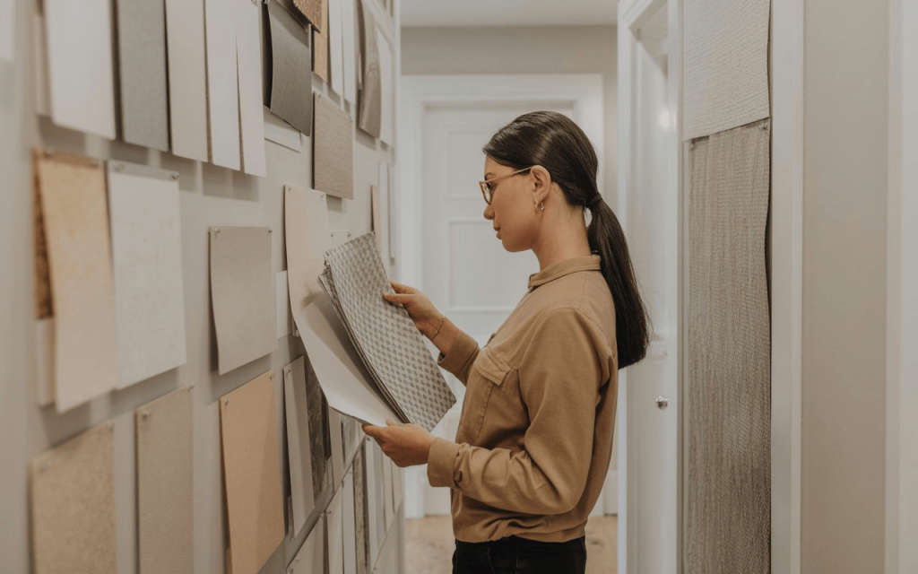 Modern hallway wallpaper ideas with woman choosing neutral patterns for stylish interior design