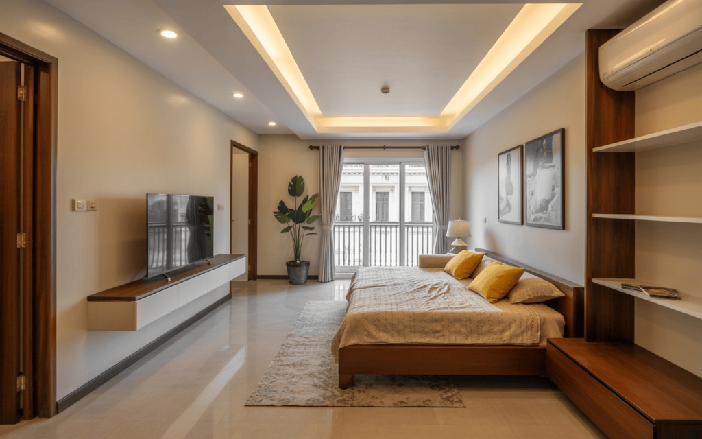  A modern living room low budget flat interior design with a sleek TV unit and false ceiling.