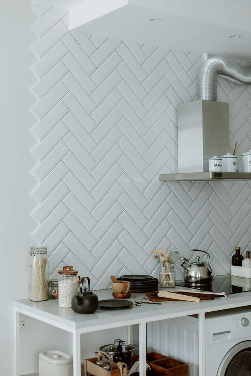 White herringbone kitchen backsplash tile pattern