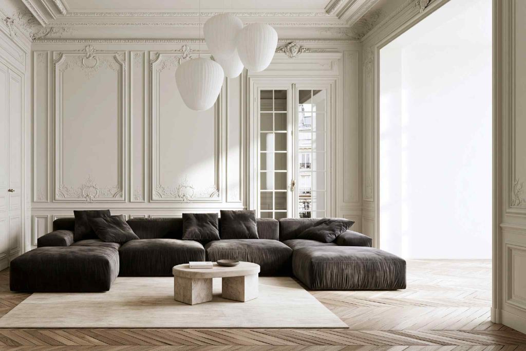 Black sofa design in white panelled living room