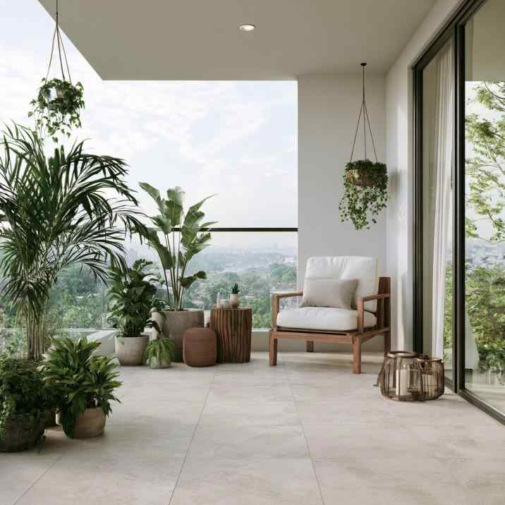 Small balcony flooring design with light tiles and plants