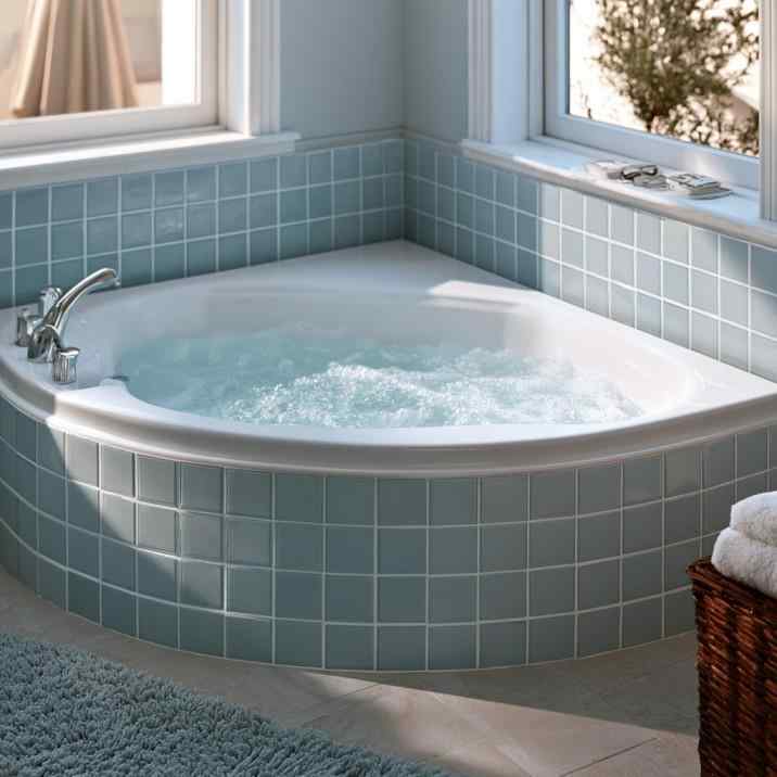 Corner bathtub tile design in soft blue tones
